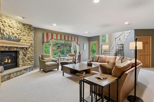 809 Saint Moritz, Victoria, MN 55386 - carpeted living area featuring stairs, a textured ceiling, recessed lighting, and a fireplace