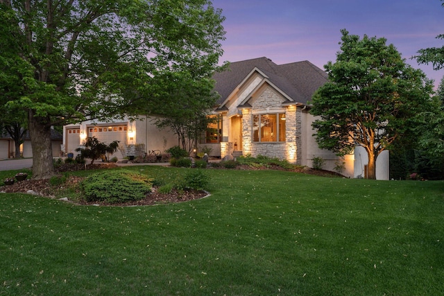809 Saint Moritz, Victoria, MN 55386 - view of front of house featuring stone siding, a yard, and an attached garage