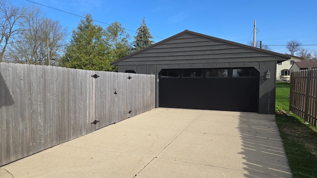 detached garage featuring fence