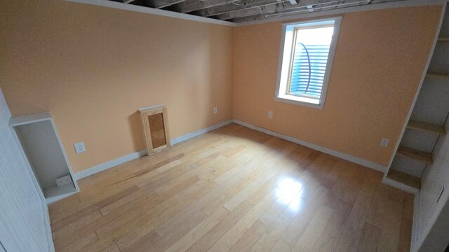 below grade area with baseboards and light wood-style flooring