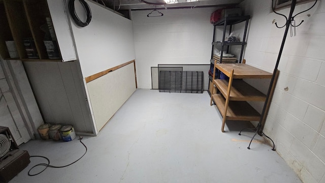 unfinished below grade area featuring concrete block wall