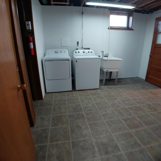 laundry room with laundry area, washer and clothes dryer, and a sink