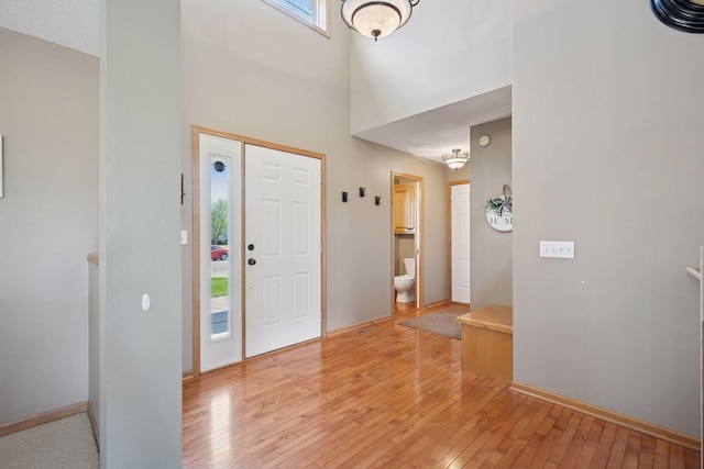 2797 Ocarina Dr, Sauk Rapids, MN 56379 - entrance foyer featuring baseboards, light wood-style flooring, and a towering ceiling