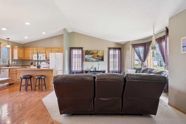 2797 Ocarina Dr, Sauk Rapids, MN 56379 - living area with recessed lighting, baseboards, light wood finished floors, and lofted ceiling