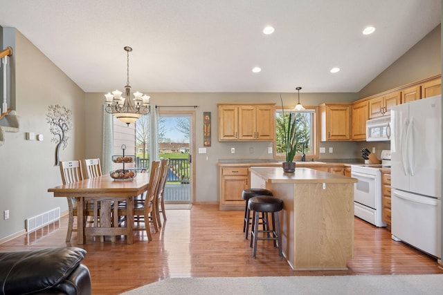 2797 Ocarina Dr, Sauk Rapids, MN 56379 - kitchen with light brown cabinets, plenty of natural light, white appliances, and visible vents