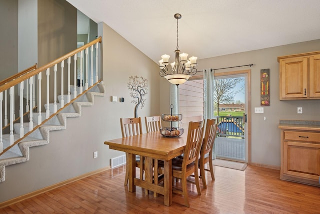 2797 Ocarina Dr, Sauk Rapids, MN 56379 - dining area with light wood-type flooring, baseboards, stairs, and a chandelier