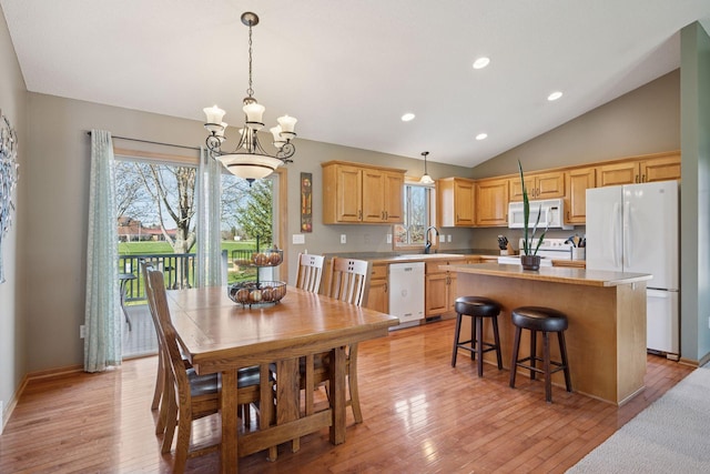 2797 Ocarina Dr, Sauk Rapids, MN 56379 - kitchen with white appliances, light brown cabinetry, a wealth of natural light, and a center island