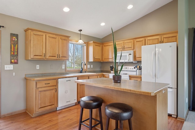 2797 Ocarina Dr, Sauk Rapids, MN 56379 - kitchen with a kitchen breakfast bar, vaulted ceiling, a sink, white appliances, and light wood-style flooring