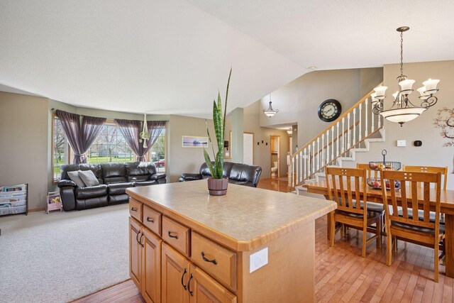 2797 Ocarina Dr, Sauk Rapids, MN 56379 - kitchen with a center island, vaulted ceiling, a chandelier, and open floor plan
