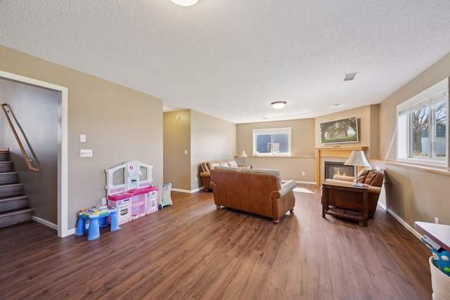 2797 Ocarina Dr, Sauk Rapids, MN 56379 - living room with stairway, a textured ceiling, wood finished floors, and visible vents