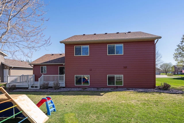 2797 Ocarina Dr, Sauk Rapids, MN 56379 - rear view of house with a lawn, a wooden deck, and roof with shingles