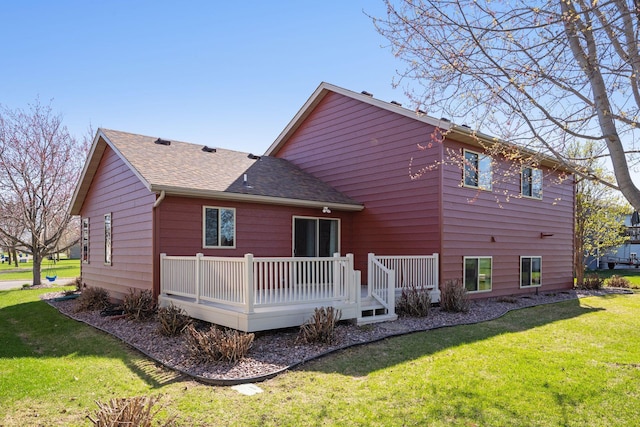2797 Ocarina Dr, Sauk Rapids, MN 56379 - back of house with a shingled roof, a wooden deck, and a yard