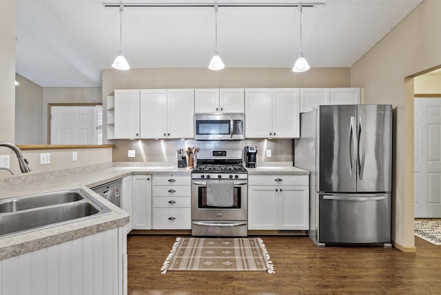 kitchen with open shelves, white cabinetry, a sink, dark wood finished floors, and stainless steel appliances