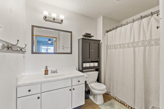 full bath featuring tile patterned flooring, vanity, toilet, a textured ceiling, and a shower with curtain