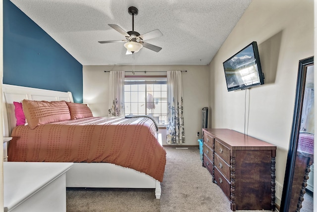 bedroom with carpet flooring, a textured ceiling, and ceiling fan