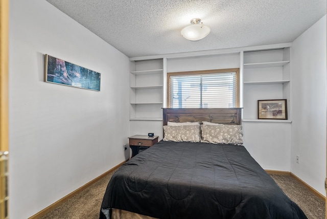 carpeted bedroom featuring baseboards and a textured ceiling