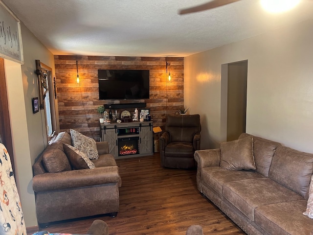 822 Holcombe Ave N, Litchfield, MN 55355 - living area featuring a textured ceiling, a lit fireplace, wood walls, and wood finished floors