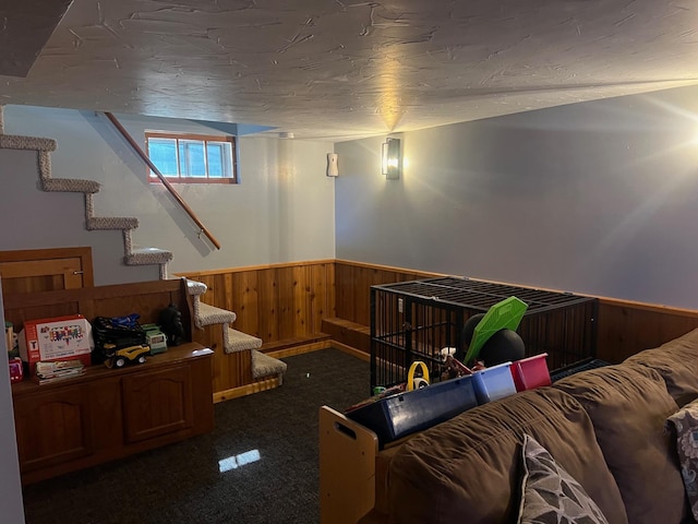 822 Holcombe Ave N, Litchfield, MN 55355 - carpeted living area featuring a wainscoted wall, wooden walls, and stairway