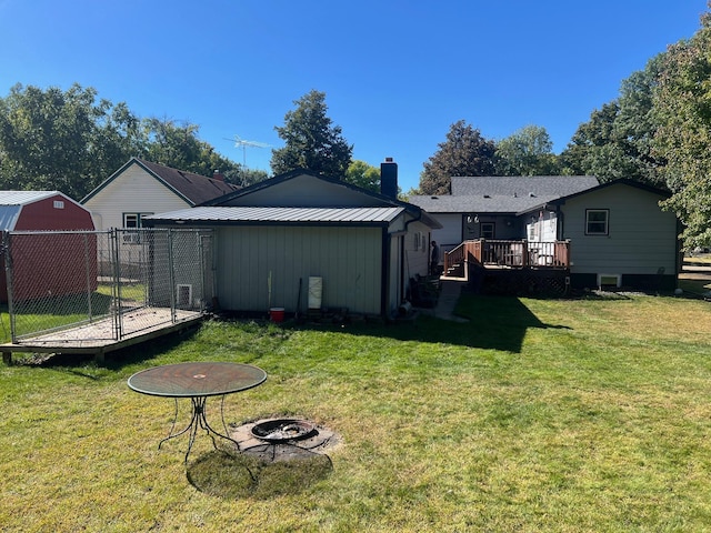822 Holcombe Ave N, Litchfield, MN 55355 - view of yard featuring an outbuilding, an outdoor fire pit, and a deck