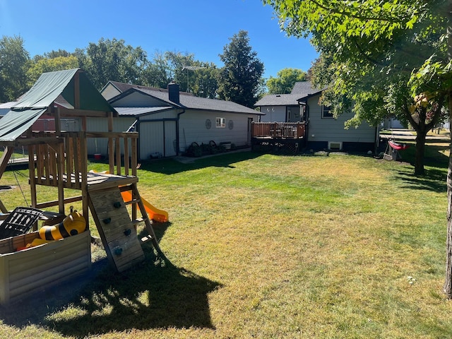 822 Holcombe Ave N, Litchfield, MN 55355 - view of yard with a wooden deck, an outdoor structure, a playground, and a shed