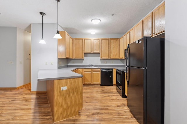 2530 34th St Unit 111, Minneapolis, MN 55406 - kitchen featuring black appliances, a peninsula, light wood-type flooring, light brown cabinetry, and a textured ceiling