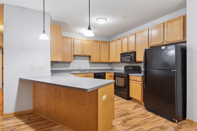 2530 34th St Unit 111, Minneapolis, MN 55406 - kitchen featuring black appliances, a sink, light brown cabinetry, a peninsula, and light wood-style floors