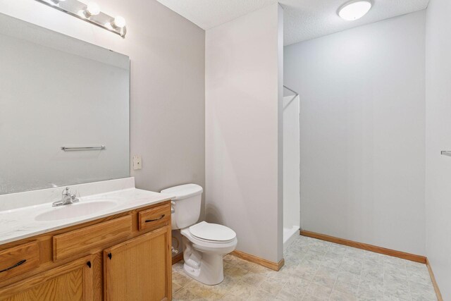 2530 34th St Unit 111, Minneapolis, MN 55406 - full bathroom featuring toilet, vanity, baseboards, and a shower