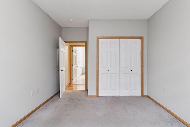 2530 34th St Unit 111, Minneapolis, MN 55406 - unfurnished bedroom featuring light carpet, baseboards, and a closet