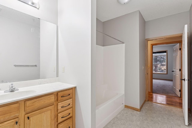 2530 34th St Unit 111, Minneapolis, MN 55406 - full bathroom with vanity, bathing tub / shower combination, and baseboards