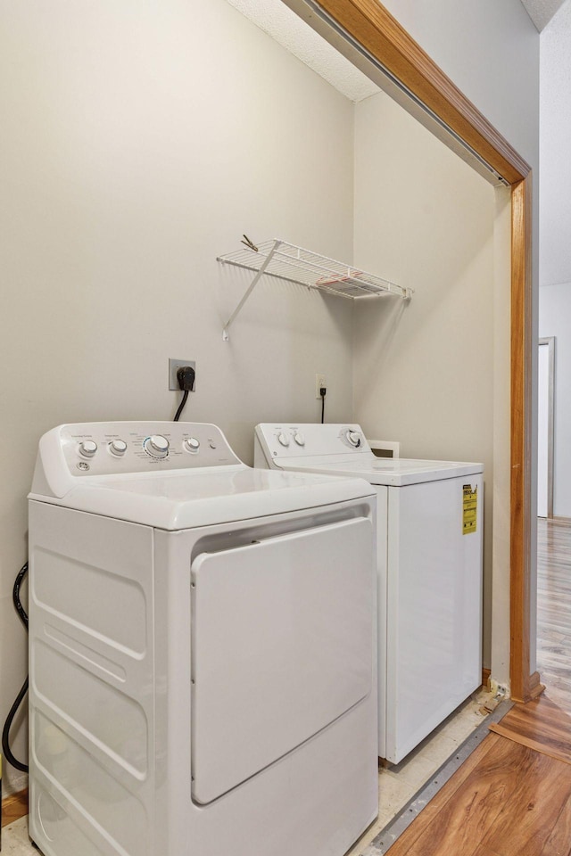 2530 34th St Unit 111, Minneapolis, MN 55406 - washroom with washing machine and dryer and light wood finished floors