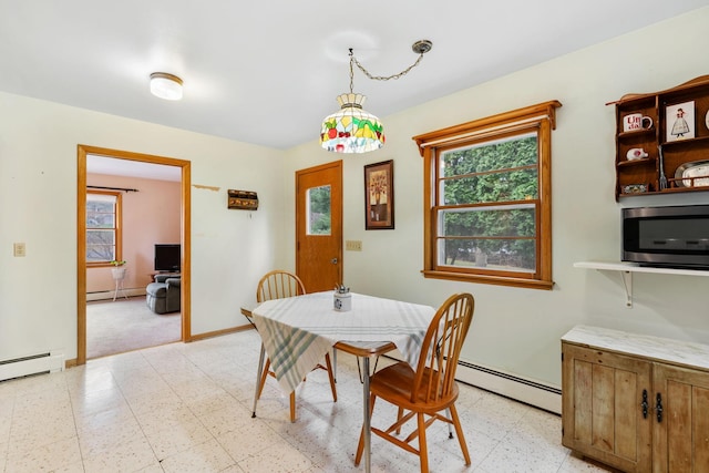 dining area featuring light floors, baseboards, and a baseboard heating unit