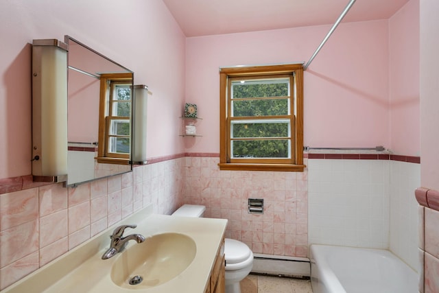 full bath with plenty of natural light, baseboard heating, toilet, and tile walls