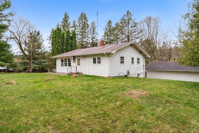 view of front of property featuring a front yard and a chimney