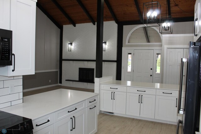 kitchen with white cabinets, light wood-style flooring, vaulted ceiling with beams, wood ceiling, and black appliances