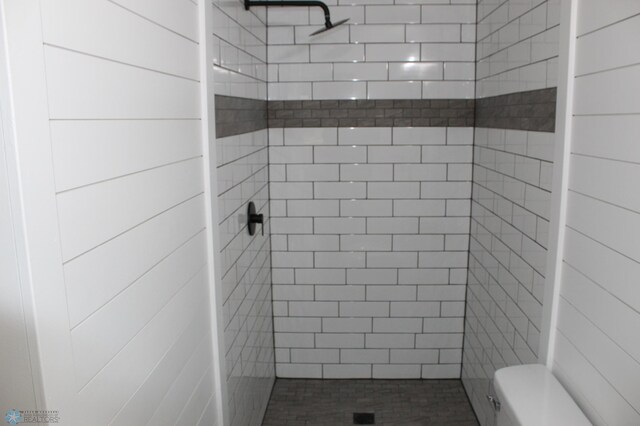 full bathroom featuring toilet and a shower stall