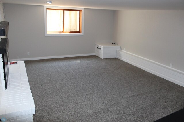 below grade area with baseboards and carpet flooring