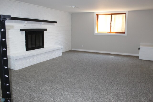 unfurnished living room featuring baseboards, carpet flooring, and a brick fireplace