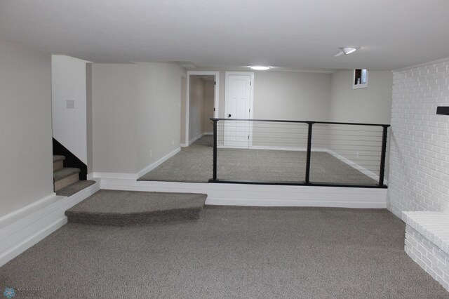 finished basement featuring carpet flooring and stairway