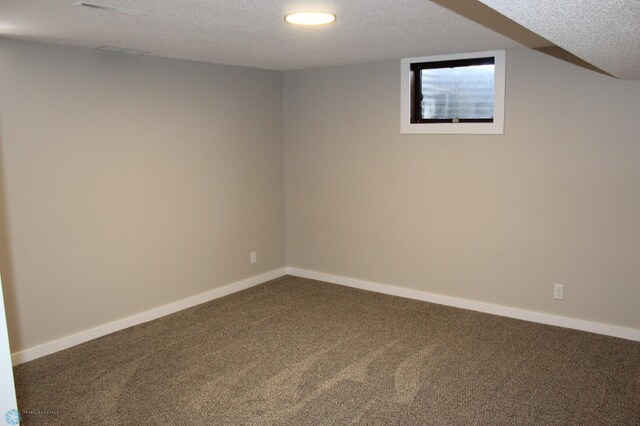 carpeted empty room with recessed lighting, a textured ceiling, and baseboards