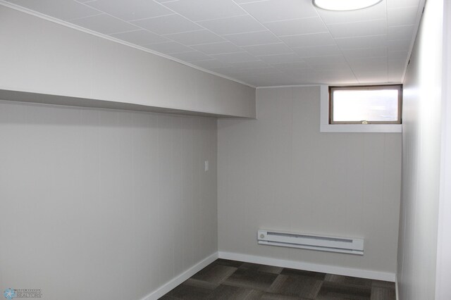 below grade area featuring baseboards and a baseboard radiator