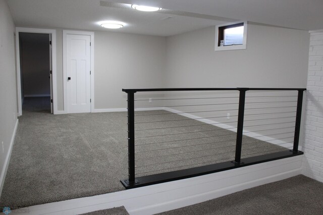 finished basement featuring baseboards and carpet flooring