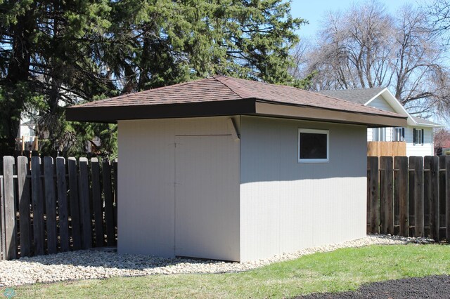 view of shed with fence