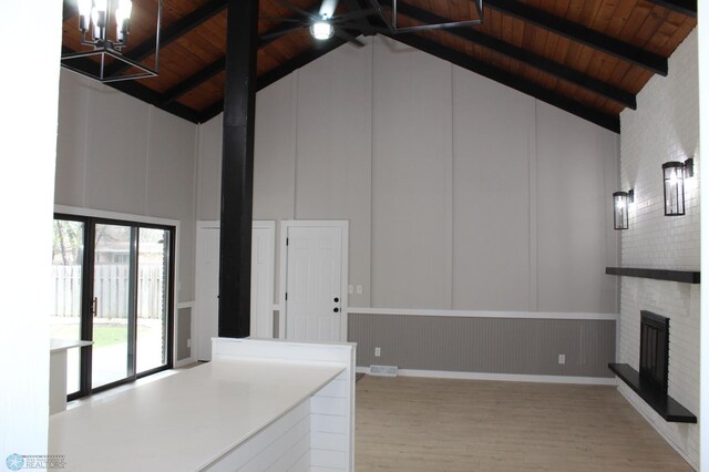 unfurnished living room featuring high vaulted ceiling, wooden ceiling, and wood finished floors