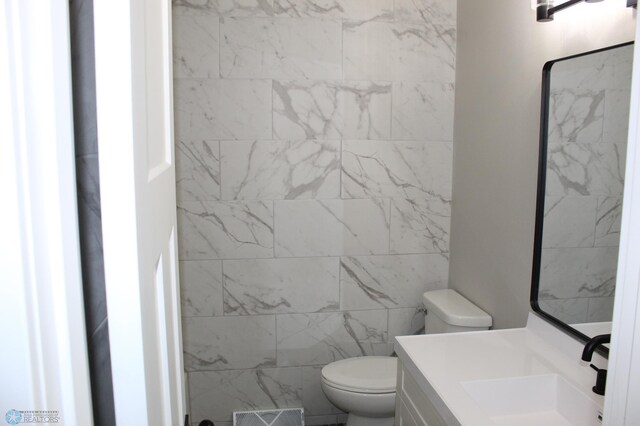 bathroom featuring toilet, visible vents, and vanity