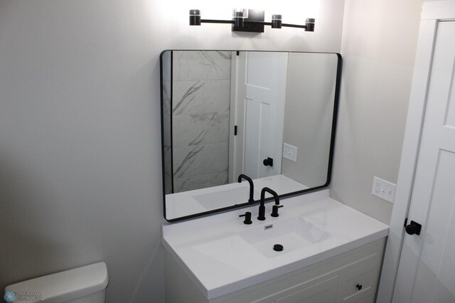 bathroom with toilet and vanity