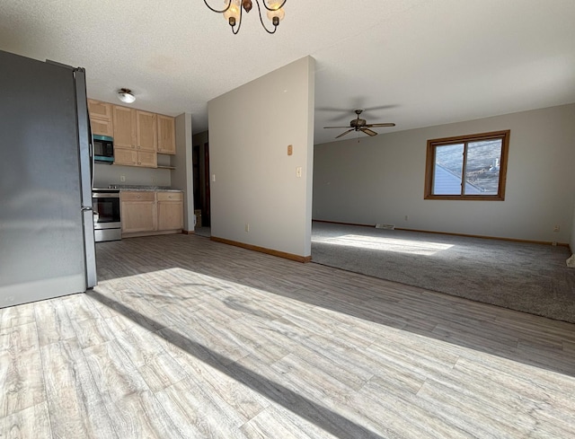 205 24th Ave N, Saint Cloud, MN 56303 - kitchen featuring appliances with stainless steel finishes, light brown cabinetry, open floor plan, and light wood finished floors