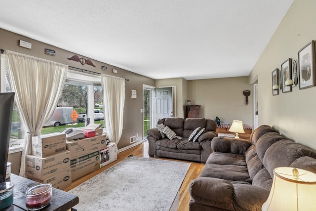 living room featuring visible vents and light wood-type flooring