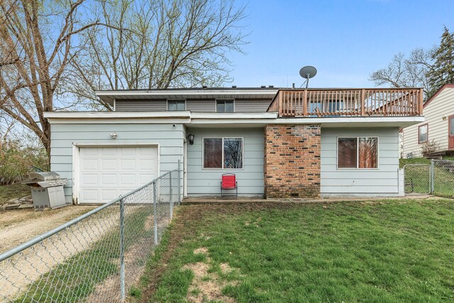 back of property featuring a garage, a balcony, a fenced backyard, dirt driveway, and a lawn