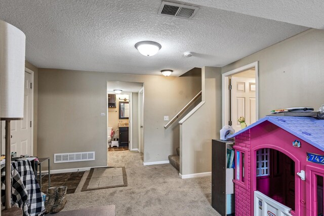 interior space with baseboards, carpet flooring, and visible vents