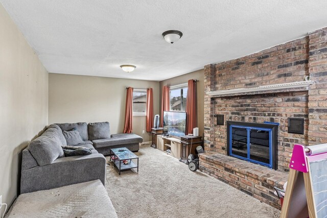 carpeted living room with baseboards, a textured ceiling, and a fireplace